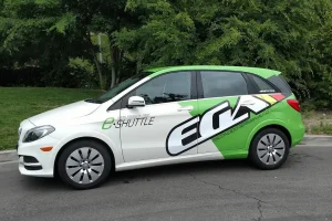 a white hatchback car wrapped with custom graphics