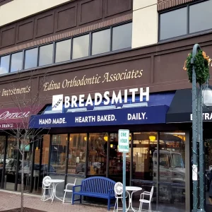 Blue awning with white vinyl lettering and white dimensional letters at a bakery