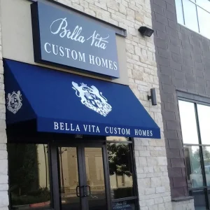 Blue cabinet sign with blue awning beneath it