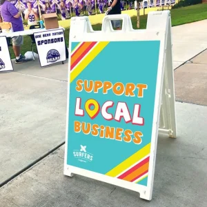 white plastic a frame sign with insert that says support local business