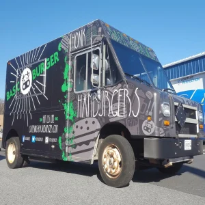 A food truck that sells hamburgers with custom vehicle wrap