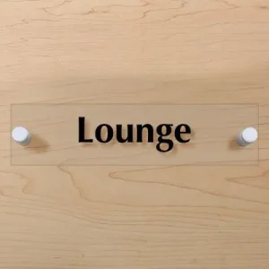Room sign that says lounge on a wall with white stand offs