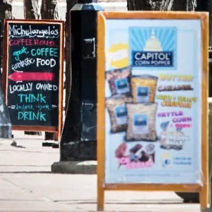 a couple of wood a frame signs that advertises food on the sidewalk