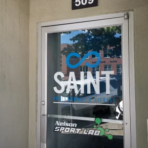 blue and white logo of a fitness facility on glass door